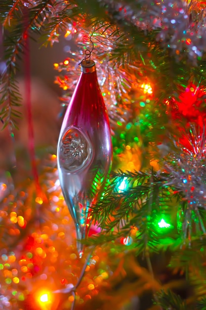 Árbol de Navidad con decoración luminosa en ramas.