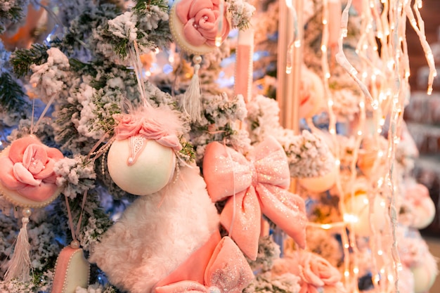 Árbol de Navidad con decoración rosa y luces, garland closeup. Decoración de Navidad, año nuevo. Celebración de vacaciones de invierno