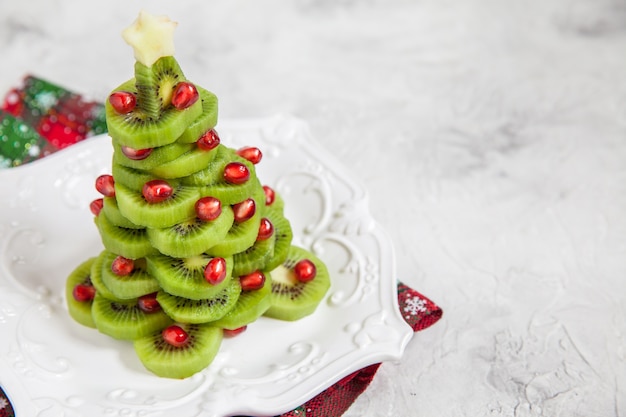 Árbol de Navidad hecho de kiwi y granada