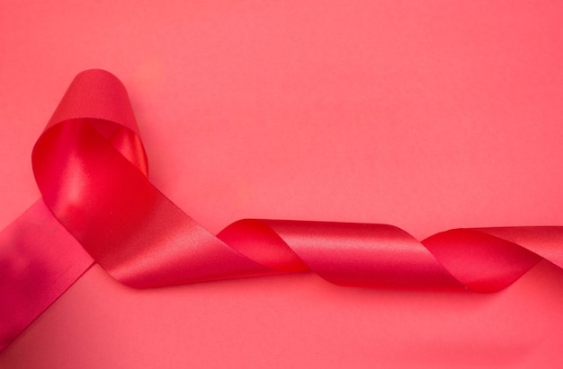 Foto realistic red ribbon breast cancer símbolo de conscientização.