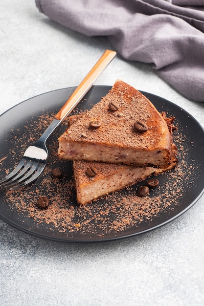 Rebanada de cazuela de cuajada de chocolate en un plato, una porción de pastel con chocolate y café. copia espacio,