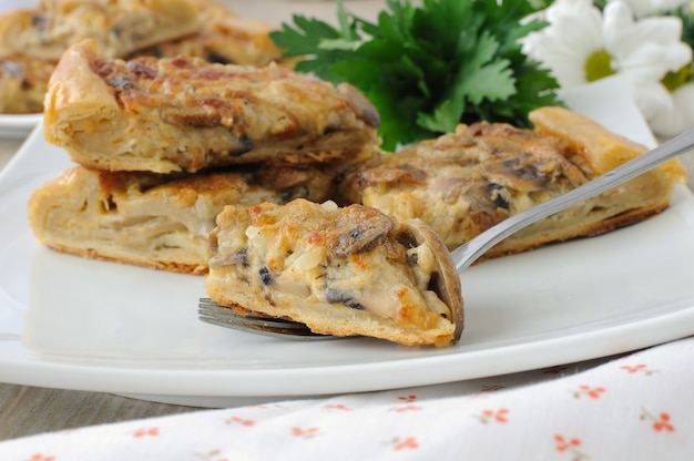 Rebanada de pastel con champiñones y salsa de crema en un tenedor