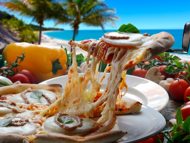 Foto rebanada de pizza caliente con queso fundido con horno de leña en segundo plano.