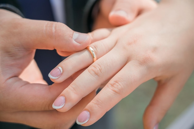 Foto recém-casados colocam alianças no dedo closeup