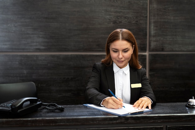 Foto recepcionista feminina em terno elegante durante o horário de trabalho