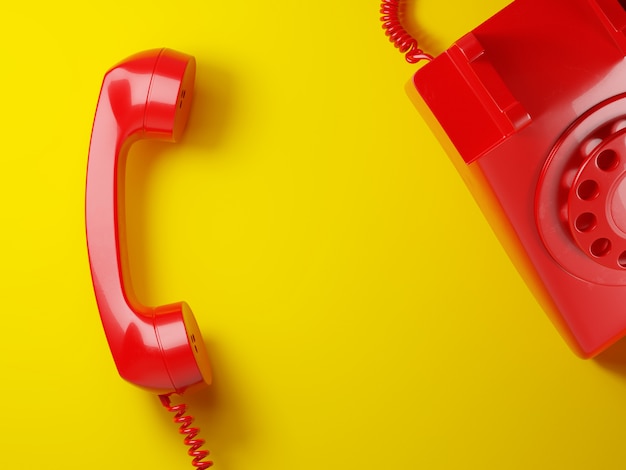 Foto receptor de telefone vintage vermelho em um fundo amarelo 3d