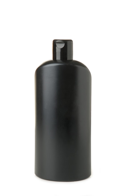 Recipiente cosmético preto isolado na parede branca. frasco de shampoo preto.