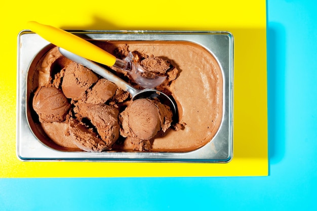 Foto un recipiente de helado de chocolate con asa amarilla y asa amarilla.