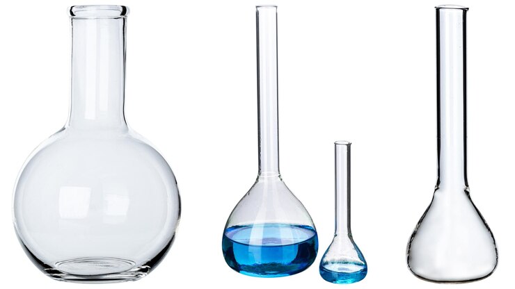 Recipientes de laboratorio de vidrio transparente vacíos con un vaso químico azul sobre fondo blanco