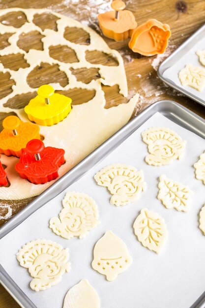 Recortando hojas de otoño con estampadora de galletas para decorar la tarta de calabaza.