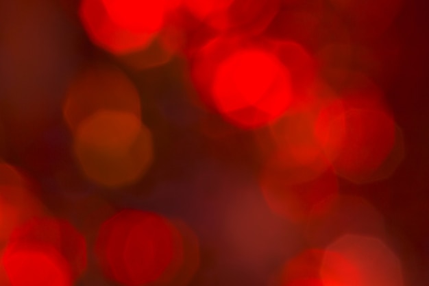 Foto refletor de luz de fundo vermelho abstrato e fundo de luzes de bokeh de brilho. a imagem está desfocada.