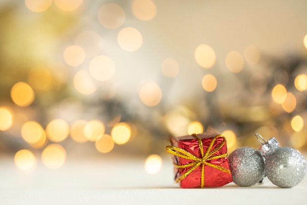 Regalo de Navidad adornos rojos y plateados contra luces bokeh fondo dorado brillante con espacio de copia