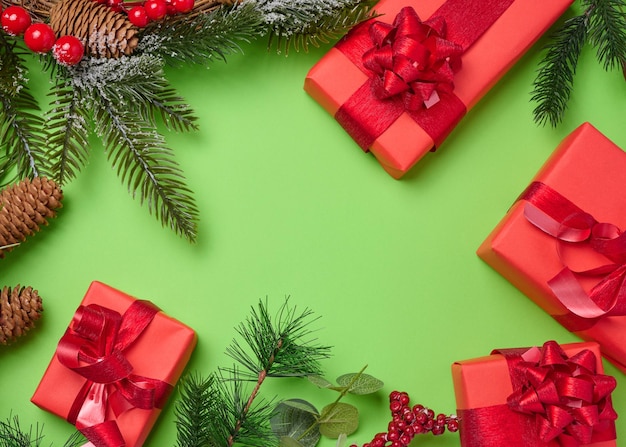 Regalos de decoración de Navidad envueltos en papel rojo en un fondo verde vista superior