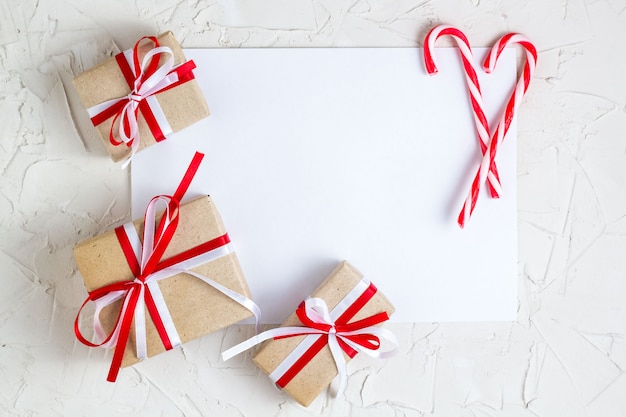 Regalos de Navidad y bastón de caramelo con tarjeta de felicitación en blanco