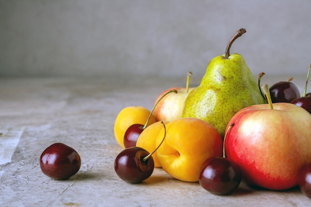 Reife Früchte auf einem selektiven Fokuskopienraum des beigen Hintergrundes