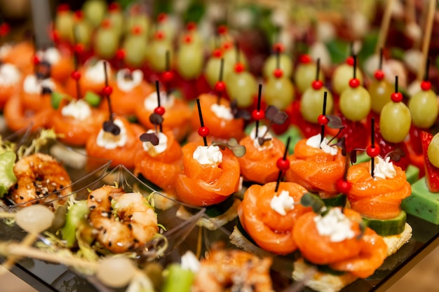 Reihen köstlicher Häppchen auf dem festlichen Tisch. Catering für Geschäftstreffen, Veranstaltungen und Feiern.