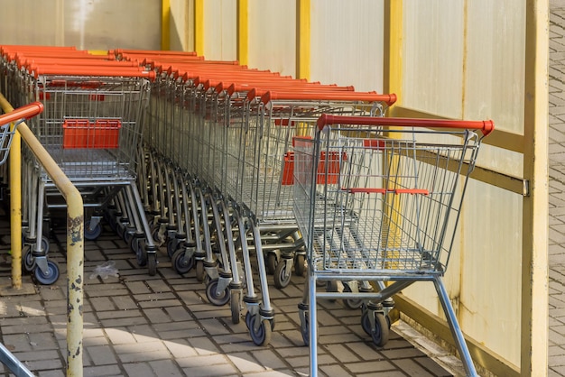 Foto reihen von lebensmitteleinkaufswagen in der nähe des eingangs des supermarkts