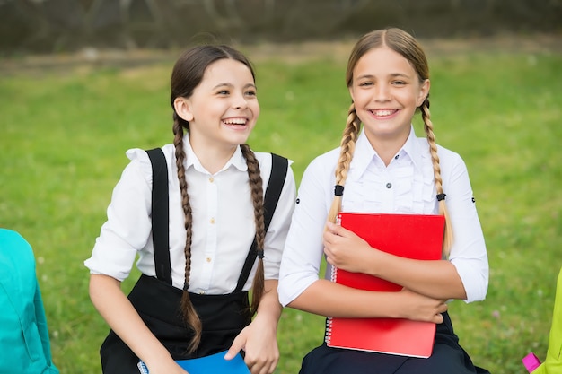 Reine Unachtsamkeit. glückliche Kindheit. zurück zur Schule. Teenager-Schüler bereit für den Unterricht. auf die Prüfung vorbereiten. gemeinsam im Freien studieren. kleine Mädchen mit Rucksäcken. Kinder halten ein Notizbuch, um Notizen zu machen.