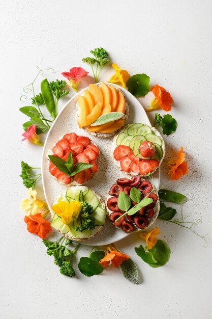 Reis-Knäckebrot mit dekorativen Belägen aus Obst und Gemüse.