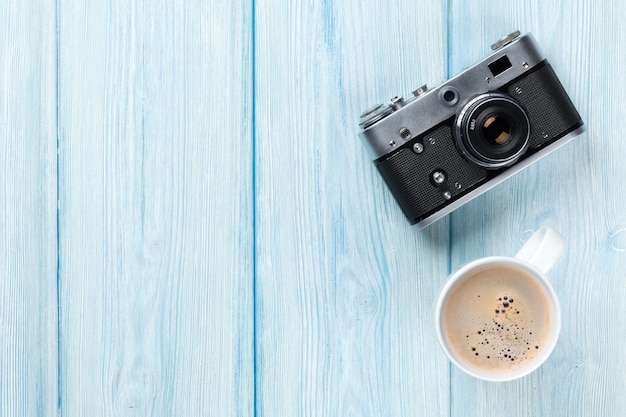 Reisekamera und Kaffeetasse auf Holztisch