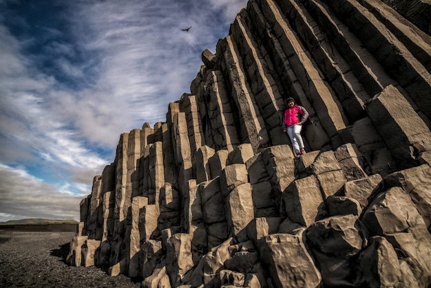 Reisender auf sechseckigen Felsen in Vik, Island.