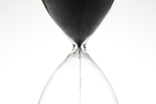 Reloj de arena sobre un fondo claro El tiempo es dinero Soluciones empresariales a tiempo