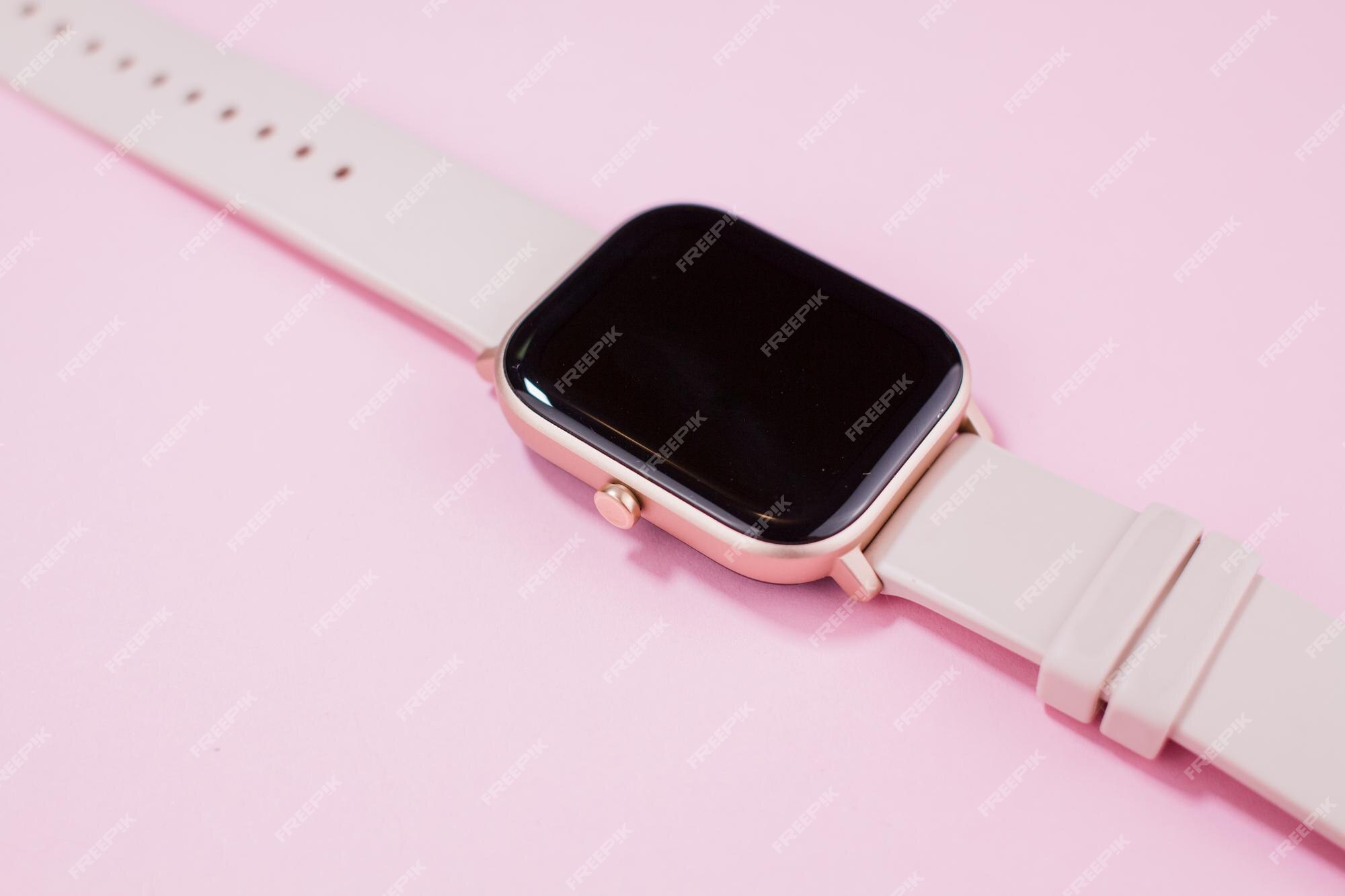 reloj para mujer con fondo rosa Foto Premium