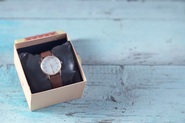 Reloj de mujer en caja sobre la mesa