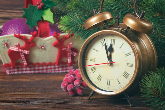 Reloj de navidad y ramas de abeto.