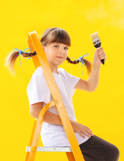 Reparação no apartamento. menina triste pintando a parede com tinta laranja