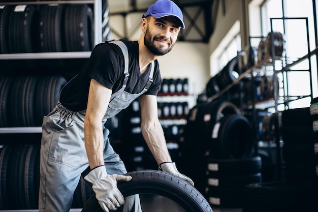 Reparador en el servicio de automóviles cambiando neumáticos