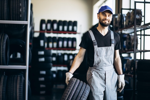 Reparador en el servicio de automóviles cambiando neumáticos