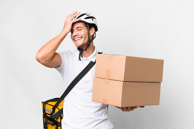 Repartidor con casco de bicicleta sobre fondo blanco aislado sonriendo mucho