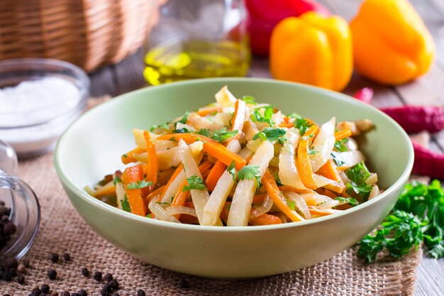 Repollo guisado con verduras en un recipiente sobre una mesa de madera