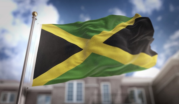 Representação 3d da bandeira da jamaica no fundo do edifício do céu azul