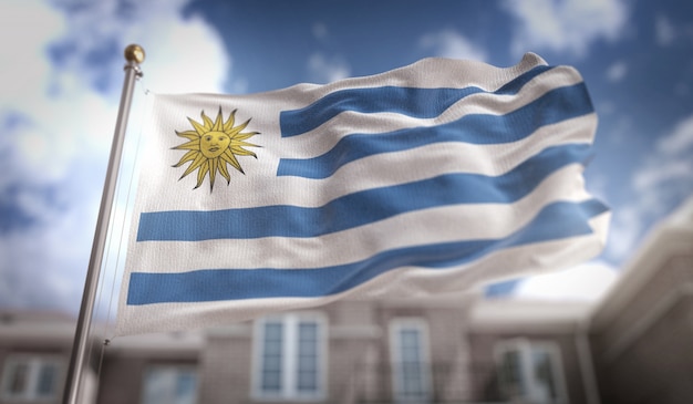 Foto representación de la bandera de uruguay 3d en el fondo del edificio del cielo azul