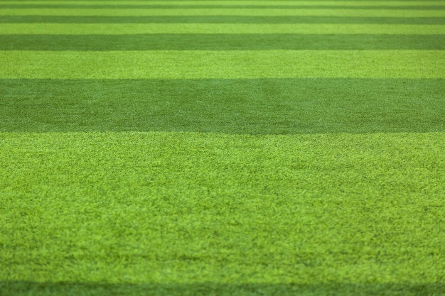 Resumen de la superficie de la hierba del césped del fondo de la hierba verde. Campo de fútbol de césped artificial