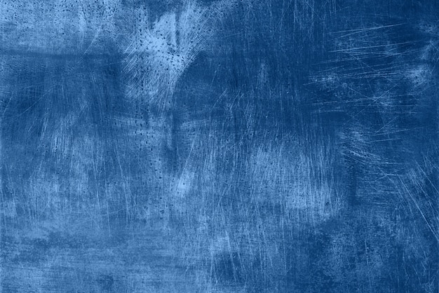 Foto resumen textura grunge monocromo oscuro con arañazos, espacio de copia. color azul de moda y tranquilo. textura concreta, fondo de piedra