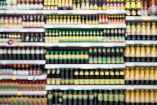 Foto resumo desfocar prateleiras de supermercado com várias garrafas de molho de tempero para fundo