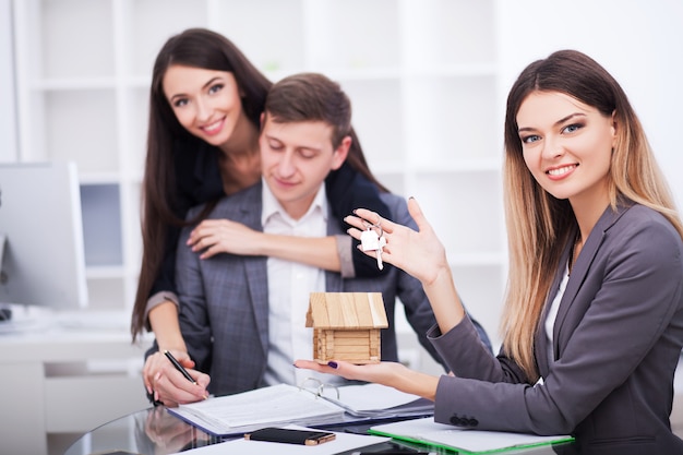 Foto retrato de agente inmobiliario con familia consiguiendo nuevo hogar