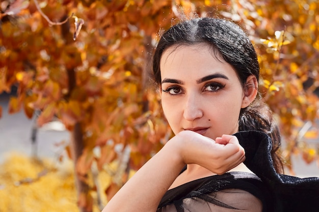 Retrato al aire libre de la hermosa mujer árabe en el jardín de otoño