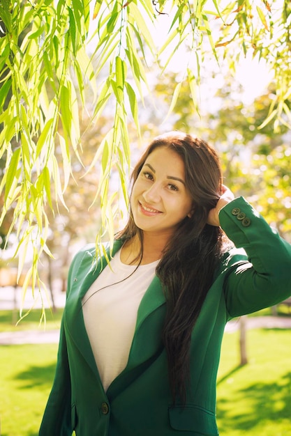 Retrato al aire libre hermoso de la mujer joven en parque