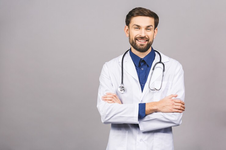 Foto retrato de alegre sonriente joven médico con estetoscopio sobre el cuello en bata médica