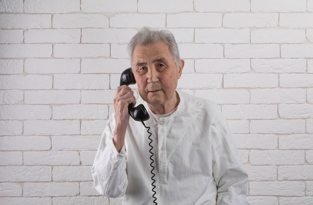 Retrato de un anciano con teléfonos antiguos