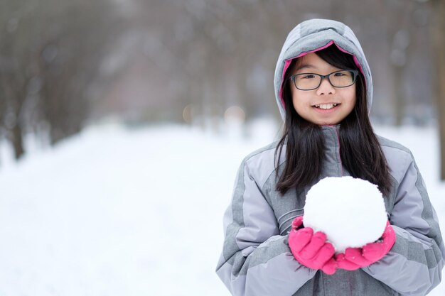 Foto retrato, de, asiático, adolescente, tenencia, un, bola de nieve, en, manos