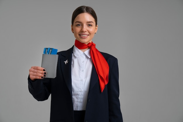 Foto retrato de asistente de vuelo con boletos de avión y pasaporte