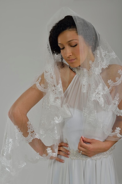 Retrato de una bella mujer vestida de novia aislada de fondo blanco en el estudio