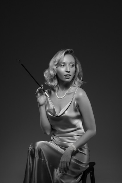 Retrato en blanco y negro de una mujer con un cigarrillo al viejo estilo glamuroso de Hollywood
