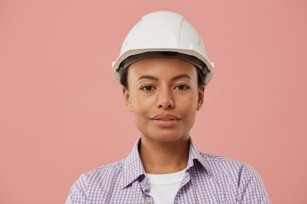 Retrato de cabeza y hombros de hermosa trabajadora con casco