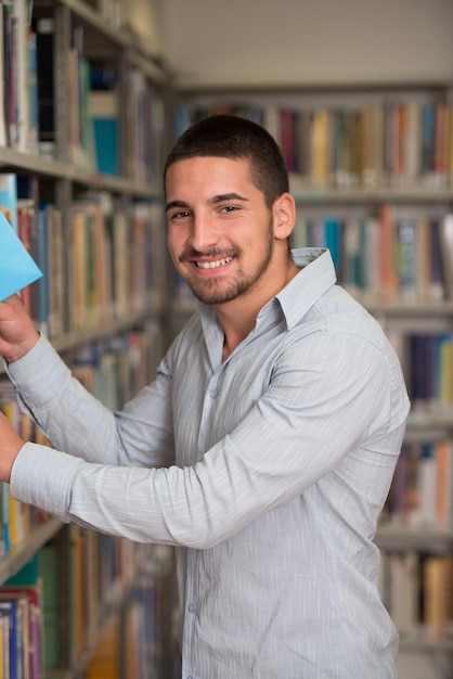 un, retrato, de, un, caucásico, estudiante universitario, hombre, en, biblioteca, poca profundidad de campo